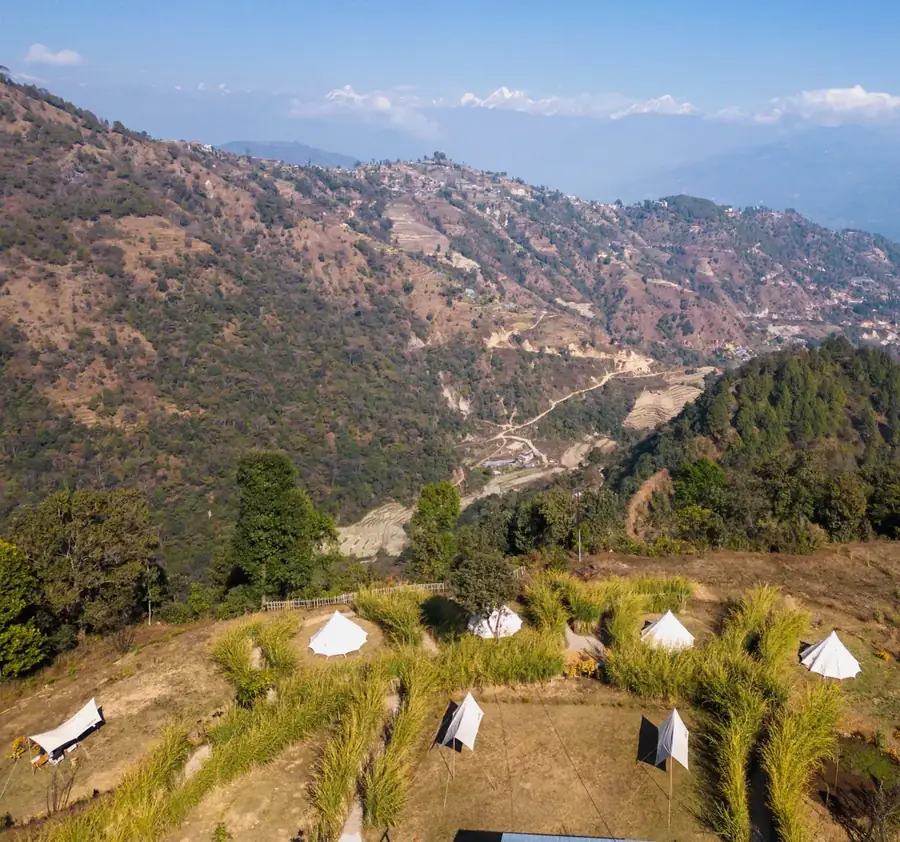 Bell tents on a terraced ridge at Nagarkot with the Himalaya on the horizon