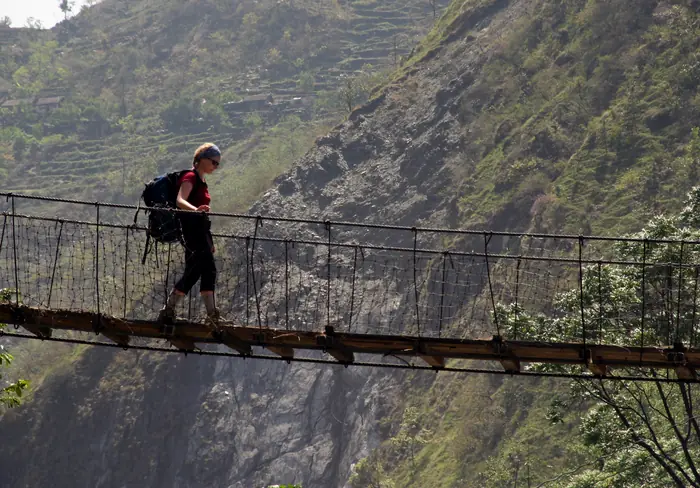 Crossing a suspension bridge high above a river gorge